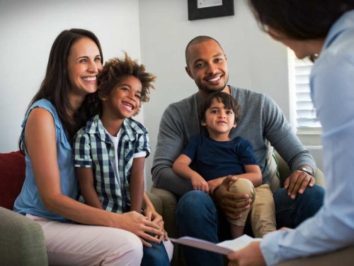 young family sitting on a couch