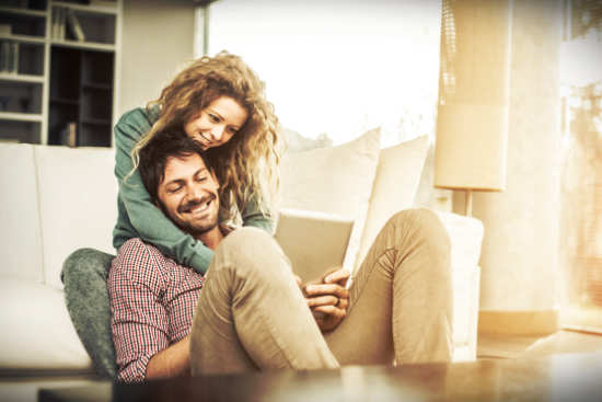 man and woman sitting and hugging