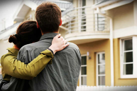 Man and woman looking at a house