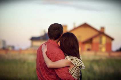 man and woman looking at a home