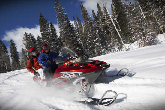 snowmobile driving through the snow