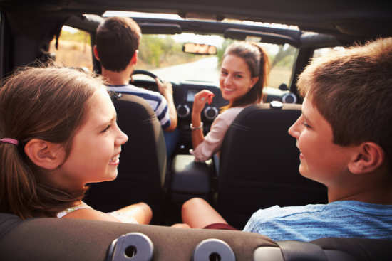 family sitting in a van