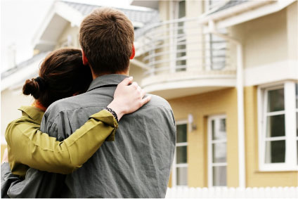 man and woman looking at a building